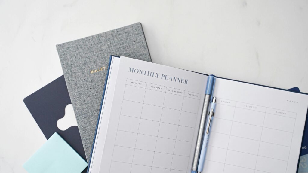 Budget planner and notebook, representing putting the 50/30/20 rule into practice