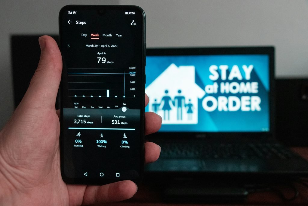 Smart thermostat app on phone, representing virtual power plant programs that pay you back
