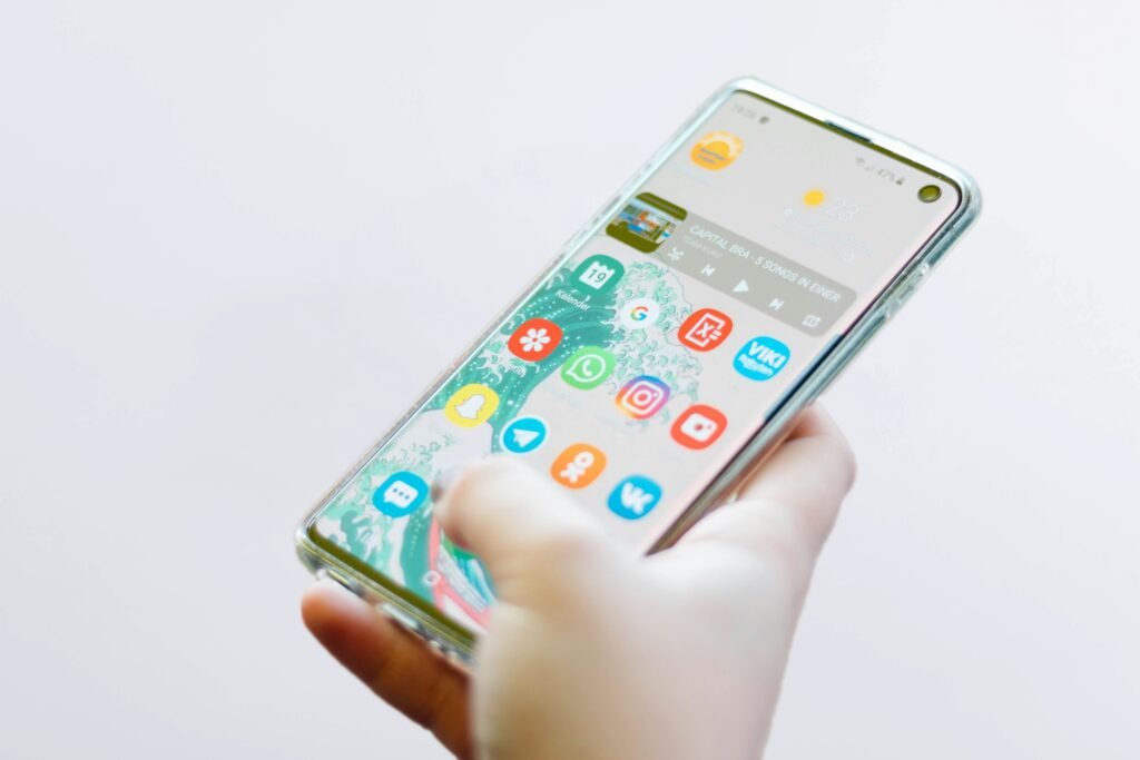 Person comparing different apps on phone, representing choosing the right budgeting app