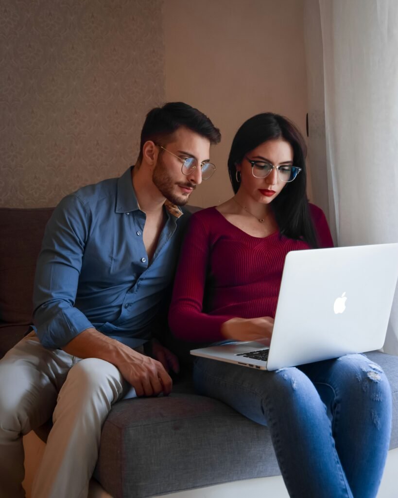 Couple budgeting together on a laptop, representing turning a money disagreement into a system