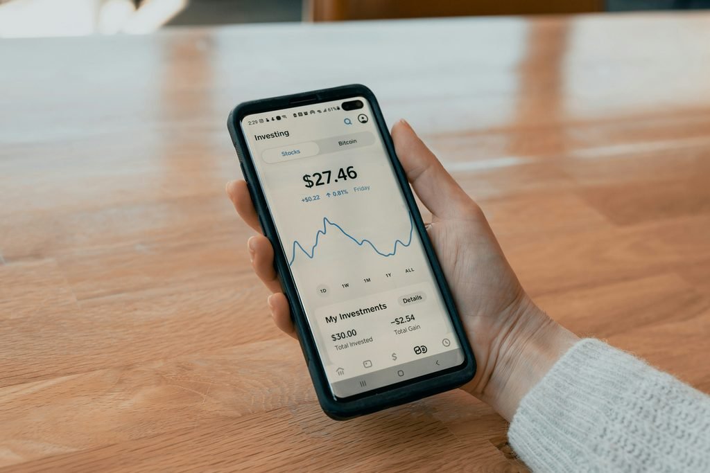 Banking app on phone showing automatic savings transfer, representing paying yourself first